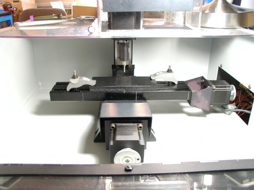 close up of mill table and end mill holder w/ 4 flute HSS endmill.