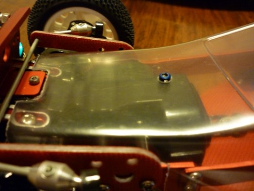 I did the same for the front mounting point, this eliminates the needs for any velcro tape, which I dislike and get the body too 'high' profile. Now the body has less than 1mm clearance with the top of the front gearbox, very close.