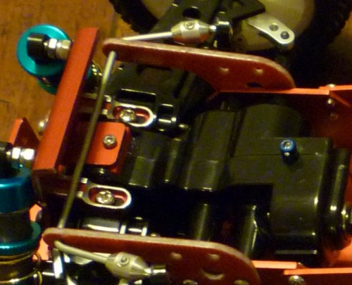 The original rc-lohas/hottrick front tower was mounted by only ONE 2.6mm short screw in the middle (the silver one), which is ridiculous!! I used a pair of servo mount, drilled the suspension arm mount from top and secured the front tower. This is rock solid now!! Note the blue aluminium screw for mounting the front of the body :)